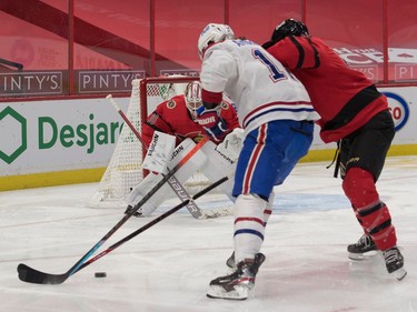 Senators goalie Matt Murray follows the puck as defenceman Mike Reilly (5) tries to cut off Canadiens right-winger Josh Anderson in the first period.