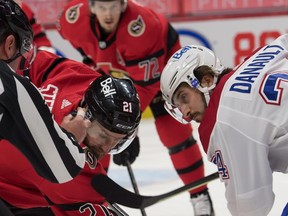 Senators centre Derek Stepan, wearing a new jersey number (21), faces off against the Canadiens' Phillip Danault  in the first period.