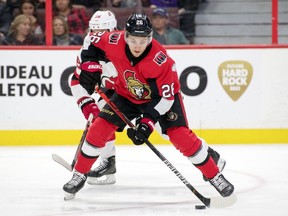 Ottawa Senators defenceman Erik Brannstrom (26) skates with the puck in front of New Jersey Devils center Jack Hughes (86) in the second period at the Canadian Tire Centre, Dec. 29, 2019.