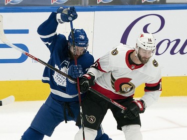 Toronto Maple Leafs defenceman T.J. Brodie (left) battles with Ottawa Senators left wing Austin Watson during the first period at Scotiabank Arena in Toronto on Monday.