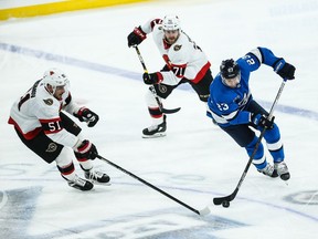 Senators forward Artem Anisimov tries to cut off Jets forward Trevor Lewis (23) during the first period at Bell MTS Place on Saturday.