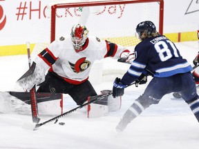 Winnipeg Jets left wing Kyle Connor (81) tries for a rebound off Ottawa Senators goaltender Marcus Hogberg (1) in the third period at Bell MTS Place.