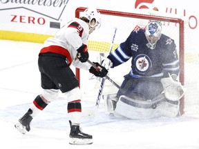Winnipeg Jets goaltender Connor Hellebuyck blocks a shot from Ottawa Senators center Josh Norris Bell MTS Place, on Feb. 11, 2021.