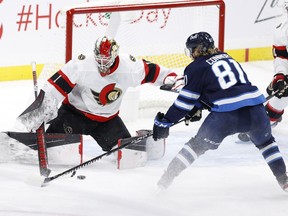 Senators netminder Marcus Hogberg makes a save against Jets left-winger Kyle Connor after replacing Matt Murray for the third period of Thursday's game at Winnipeg.