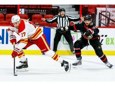 Calgary Flames left wing Milan Lucic gets past Ottawa Senators center Artem Anisimov during second period on Thursday.