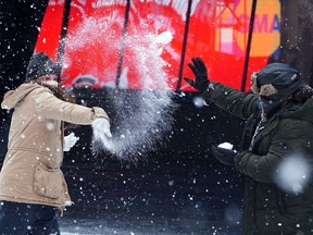 FILE: People have a snowball fight.