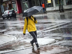 Pedestrians make their way along Bank Street in the rain.