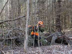 Search and rescue volunteers look through the remains of an old vehicle as the ground search for missing three year old Jude Walter Leyton who went missing Sunday near Verona, Ont. on Tuesday, March 30, 2021.