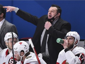 Head coach of the Ottawa Senators D. J. Smith pulls down his mask to call out instructions against the Montreal Canadiens during the third period at the Bell Centre on February 4, 2021.