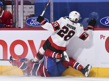 Connor Brown of the Senators falls over Brendan Gallagher of the Canadiens during the first period.