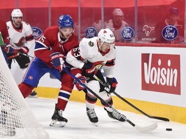 Evgenii Dadonov of the Senators skates with the puck against Jesperi Kotkaniemi of the Canadiens during the first period.