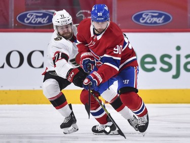 Chris Tierney of the Senators and Tomas Tatar of the Canadiens skate after the puck during the first period.