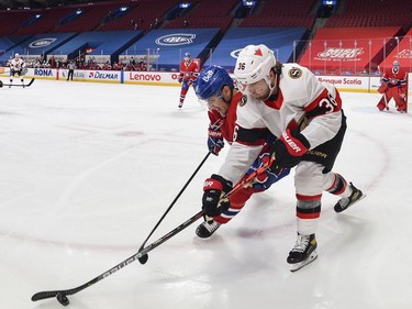 Nick Suzuki of the Canadiens challenges Colin White of the Senators during the first period.