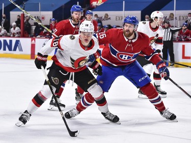 Senators winger Tim Stuetzle tries to hold off Jeff Petry of the Canadiens during first-period action.