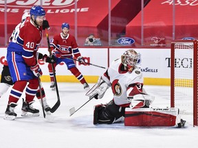 The Ottawa Senators' Joey Daccord redirects the puck with his glove near Joel Armia of the Montreal Canadiens during the second period at the Bell Centre on March 2, 2021.