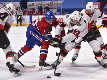 Nick Suzuki of the Canadiens and Nick Paul of the Senators battle for the puck during the second period.