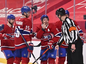 Winger Brendan Gallagher shows referee Eric Furlatt that he is bleeding after receiving a high stick following a goal by the Canadiens during the second period of Tuesday's game against the Senators.