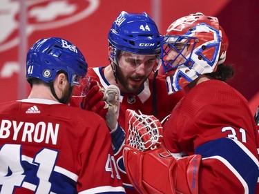 Canadiens goaltender Carey Price celebrates Tuesday's victory against the Senators with teammates Paul Byron, left, and Joel Edmundson.