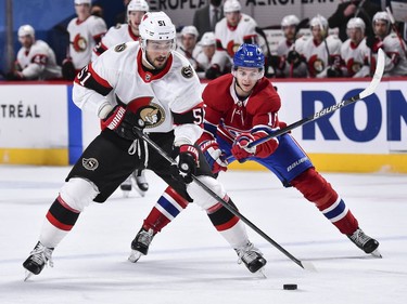 Artem Anisimov of the Senators skates the puck against Jesperi Kotkaniemi of the Canadiens during the third period.