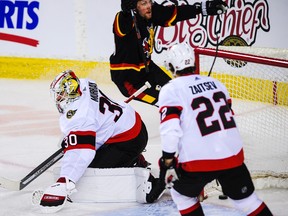 Brett Ritchie #24 of the Calgary Flames celebrates after scoring against Matt Murray #30 of the Ottawa Senators.
