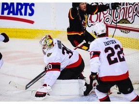 CALGARY, AB - MARCH 4: Brett Ritchie #24 of the Calgary Flames celebrates after scoring against Matt Murray #30 of the Ottawa Senators during an NHL game at Scotiabank Saddledome on March 4, 2021 in Calgary, Alberta, Canada.