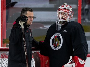 Files: Former Ottawa Senators goaltending coach Pierre Groulx talks with goaltender Filip Gustavsson during team practice at the Canadian Tire Centre in March, 2021.