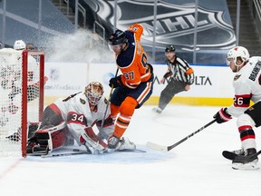 Edmonton Oilers' Connor McDavid (97) is stopped by Ottawa Senators' goaltender Joey Daccord (34) during third period NHL action at Rogers Place in Edmonton, on Monday, March 8, 2021.