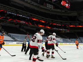 Ottawa Senators' Colin White (36) is hurt after a collision with Edmonton Oilers' William Lagesson (84) during second period NHL action at Rogers Place in Edmonton, on Wednesday, March 10, 2021.