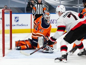 Senators winger Brady Tkachuk tips the puck past Oilers netminder Mike Smith for a goal in the second period of Friday's game at Edmonton.