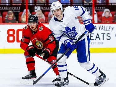 Senators left-winger Tim Stuetzle keeps a close eye on Maple Leafs winger Mitch Marner during the second period.
