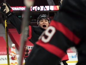 Senators rookie Tim Stuetzle (18) celebrates after a goal by teammate Drake Batherson against the Flames on Monday.