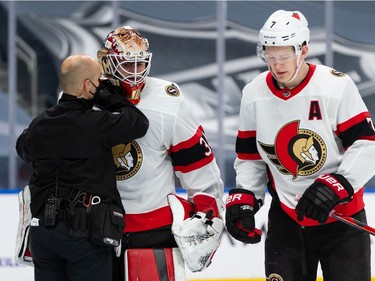 Ottawa Senators' goaltender Joey Daccord (34) is checked by medical staff after teammate Brady Tkachuk (7) shoved EDMONTON Oilers' Gaetan Haas (91) into his net during third period NHL action at Rogers Place in Edmonton, on Friday,
