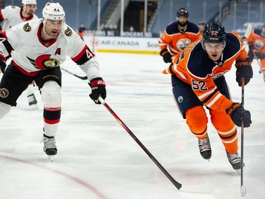 Edmonton Oilers' Patrick Russell (52) races Ottawa Senators' Erik Gudbranson (44) during third period NHL action at Rogers Place in Edmonton, on Friday, March 12, 2021.