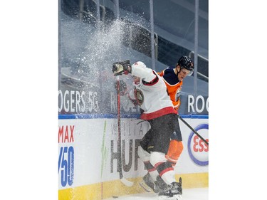 Edmonton Oilers' Jesse Puljujarvi (13) battles Ottawa Senators' Erik Gudbranson (44) during third period NHL action at Rogers Place in Edmonton, on Friday, March 12, 2021