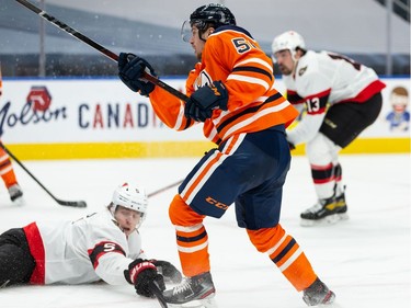 Edmonton Oilers' Kailer Yamamoto (56) fires a shot past a diving Ottawa Senators' Mike Reilly (5) during third period NHL action at Rogers Place in Edmonton, on Friday, March 12, 2021.