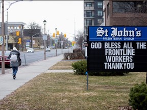 A sign seen from a church after movement restrictions came into effect due to COVID-19 in the border town of Cornwall, Ont., March 25, 2020.