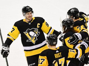 Sidney Crosby of the Pittsburgh Penguins and his teammates celebrate a goal against the New York Islanders at PPG PAINTS Arena on Feb. 20, 2021 in Pittsburgh.