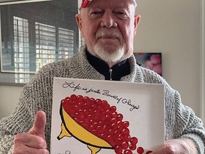 Hockey legend Grapes gives his classic thumbs up while holding his creation called Life is a Bowl of Cherries, a painting that will be auctioned off to raise money for the Don Cherry Pet Rescue Foundation.