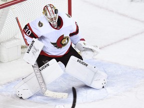 Goalie Matt Murray (30) stops a shot  from the Calgary Flames.