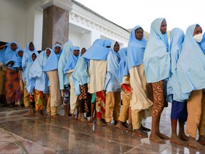 Girls who were kidnapped from a boarding school in the northwest Nigerian state of Zamfara, walk in line after their release in Zamfara, Nigeria March 2, 2021.