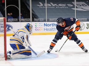 Mathew Barzal of the New York Islanders scores against Buffalo Sabres goaltender Carter Hutton using a between-the-legs shot on March 6, 2021.