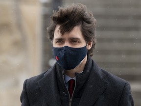 Prime Minister Justin Trudeau makes his way to a news conference in Ottawa, Friday, Feb. 19, 2021.