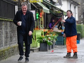 A passerby gestures to journalist and television presenter Piers Morgan after he left his high-profile breakfast slot with the broadcaster ITV following his long-running criticism of Prince Harry's wife, Meghan.