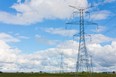 A line of hydro towers reach into the distance in Bruce County, Ont.