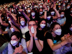 Music fans in Barcelona hugged, danced and sang along at a sold-out rock concert on Saturday night after taking rapid COVID-19 tests in a trial that could revive the live music industry in Spain and beyond. Some 5,000 fans at the show for Spanish indie band Love of Lesbian had to wear masks but social distancing was not required in the Palau Sant Jordi arena. Is this what the future of concert-going looks like?