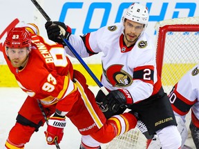 Calgary Flames Sam Bennett battles against Artem Zub of the Ottawa Senators during NHL hockey in Calgary on Sunday March 7, 2021.