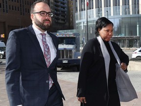 Aissatou Diallo, the OC Transpo driver who faces dangerous driving charges after the 2019 crash of an OC Transpo bus at Westboro station, walks to the court house with her lawyer Solomon Friedman.