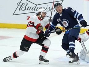 Winnipeg Jets centre Paul Stastny is tied up with Ottawa Senators defenceman Christian Wolanin, Feb. 11, 2021.