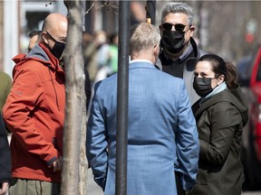 People mask up outside a trendy coffee shop on St-Viateur St. in Montreal, on Wednesday, April 7, 2021.