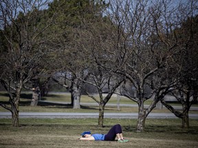 OTTAWA -April 10, 2021 - A woman has a little nap in the warm sun near the Aviation Museum.